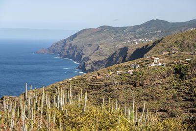 Scenic view of sea and mountains against sky