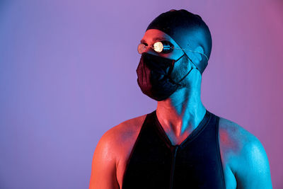 Portrait of young man against blue background