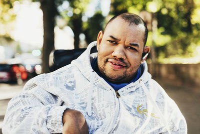 Portrait of happy disabled man wearing jacket outdoors