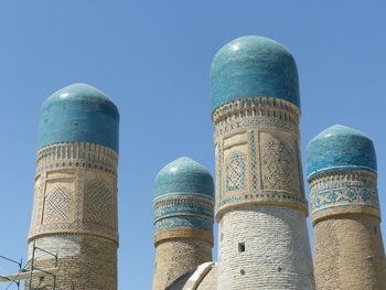 Low angle view of communications tower against blue sky