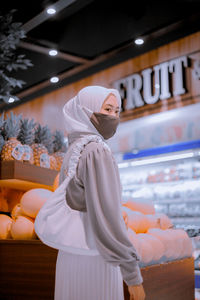 Midsection of woman standing in store