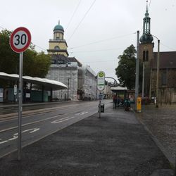 View of city street and buildings against sky