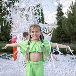 Portrait of smiling girl standing outdoors