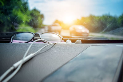 Close-up of car on road against sky