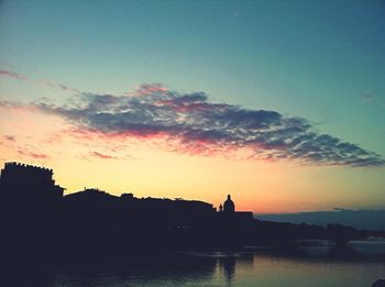 Silhouette trees against sky at sunset