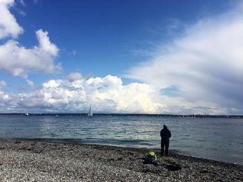 Man standing on beach against sky