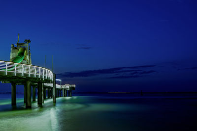 Scenic view of sea against blue sky at dusk