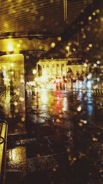 Wet illuminated city at night