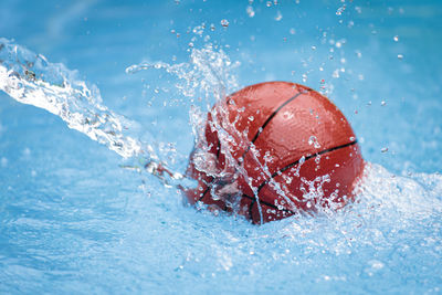 Close-up of a ball splashing on water