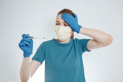 Midsection of man standing against blue background