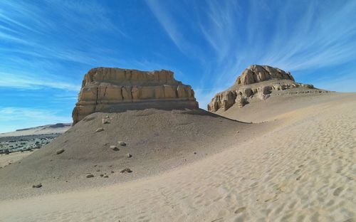 Scenic view of arid landscape against sky