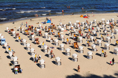 High angle view of hooded beach chairs at beach during summer