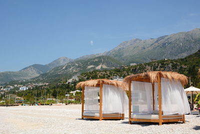 Rear view of built structure on landscape against mountain range