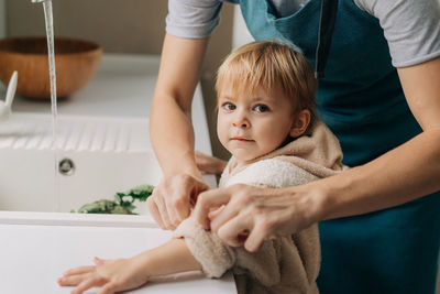 High angle view of mother and daughter in bathroom