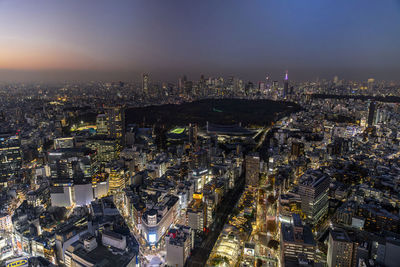 High angle view of illuminated cityscape against sky at night