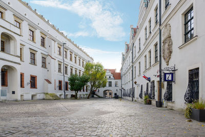 Street amidst buildings against sky