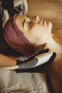 High angle portrait of woman relaxing on bed