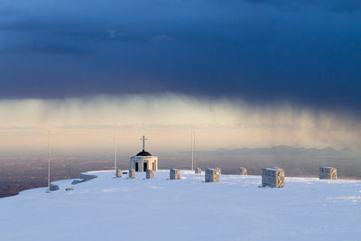 Snow covered landscape against sky