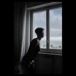 Woman looking through window