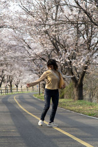Full length of woman walking on road
