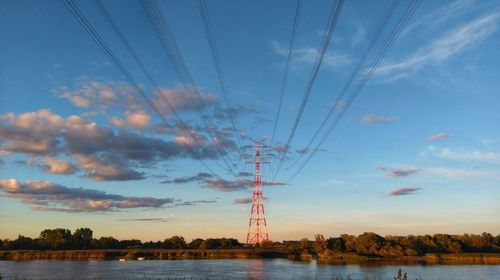 Electricity pylon against sky during sunset