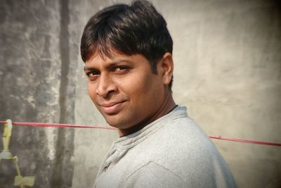 Close-up portrait of man holding water