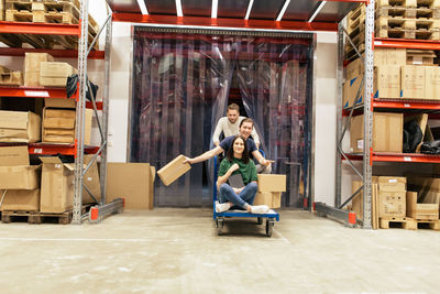Male and female coworkers enjoying while working at warehouse