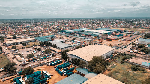 High angle view of townscape by sea against sky