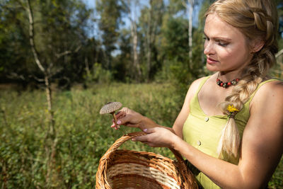 Portrait of young woman sitting in forest