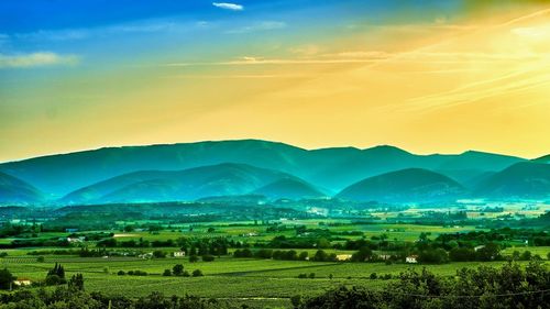 Scenic view of field against sky during sunset