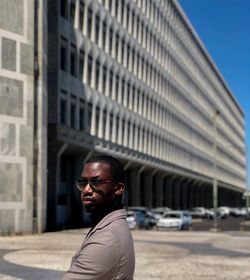Portrait of young man standing in city