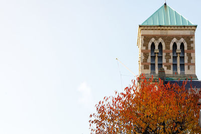 Low angle view of building against sky during autumn