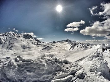 Scenic view of snow covered mountains against sky