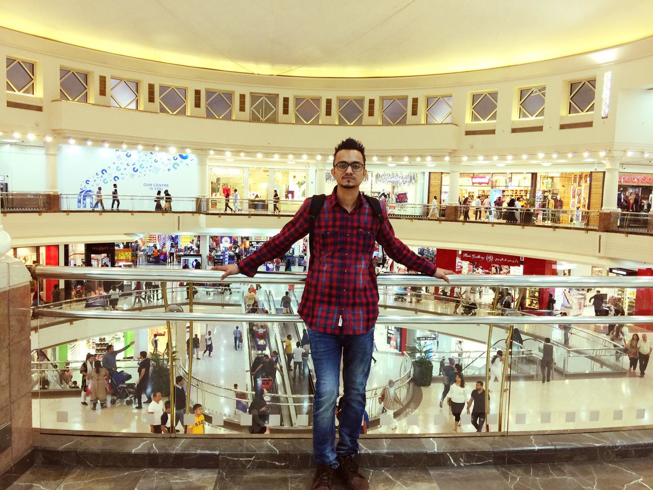 front view, standing, store, one person, looking at camera, real people, portrait, indoors, lifestyles, casual clothing, shopping mall, young adult, incidental people, retail, illuminated, shopping, leisure activity, full length, emotion, consumerism, retail display, hairstyle