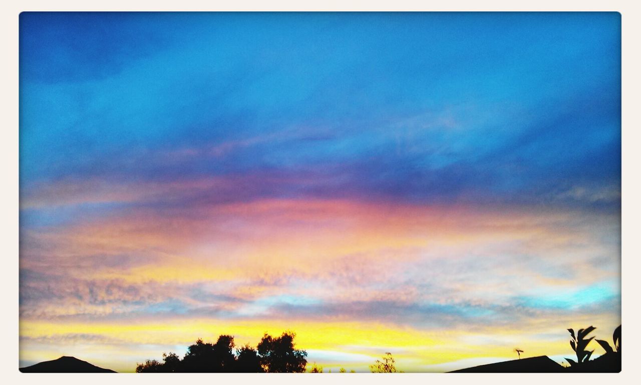 sunset, sky, transfer print, beauty in nature, cloud - sky, scenics, tranquility, tranquil scene, auto post production filter, silhouette, nature, cloud, tree, low angle view, dramatic sky, orange color, blue, cloudy, idyllic, moody sky