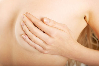 Close-up of woman covering breast