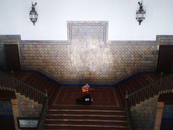 Woman standing on staircase of building