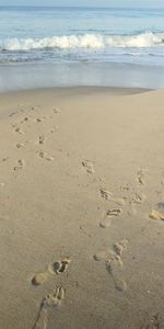 High angle view of footprints on sand at beach