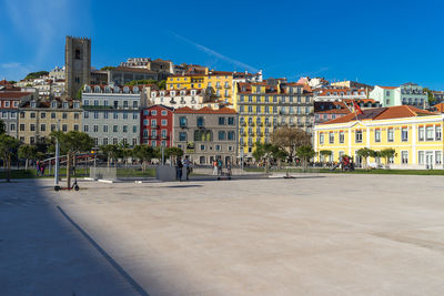 Buildings in city against blue sky