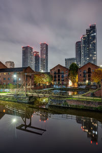 Historic castlefield in manchester at night with the modern skyline in the back