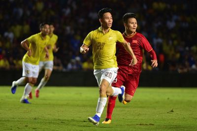 Full length of man running on soccer field