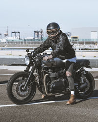 Portrait of man riding motorcycle on road