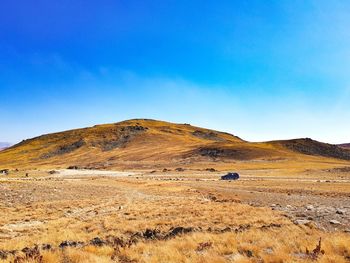 Scenic view of mountain against blue sky