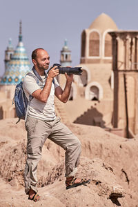 Man with camera at historic place