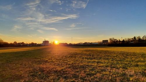 Scenic view of field against sky during sunset