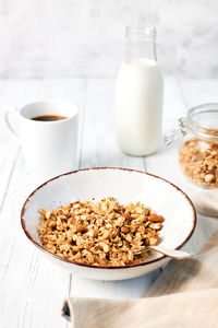 Granola with nuts and a cup of coffee for breakfast. balanced diet for vegetarians or vegans