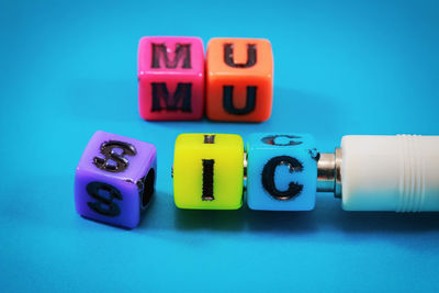 Colorful letter toy blocks on blue background