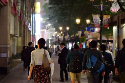 Women with purse walking on busy street 