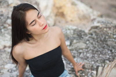 High angle view of young woman with eyes closed