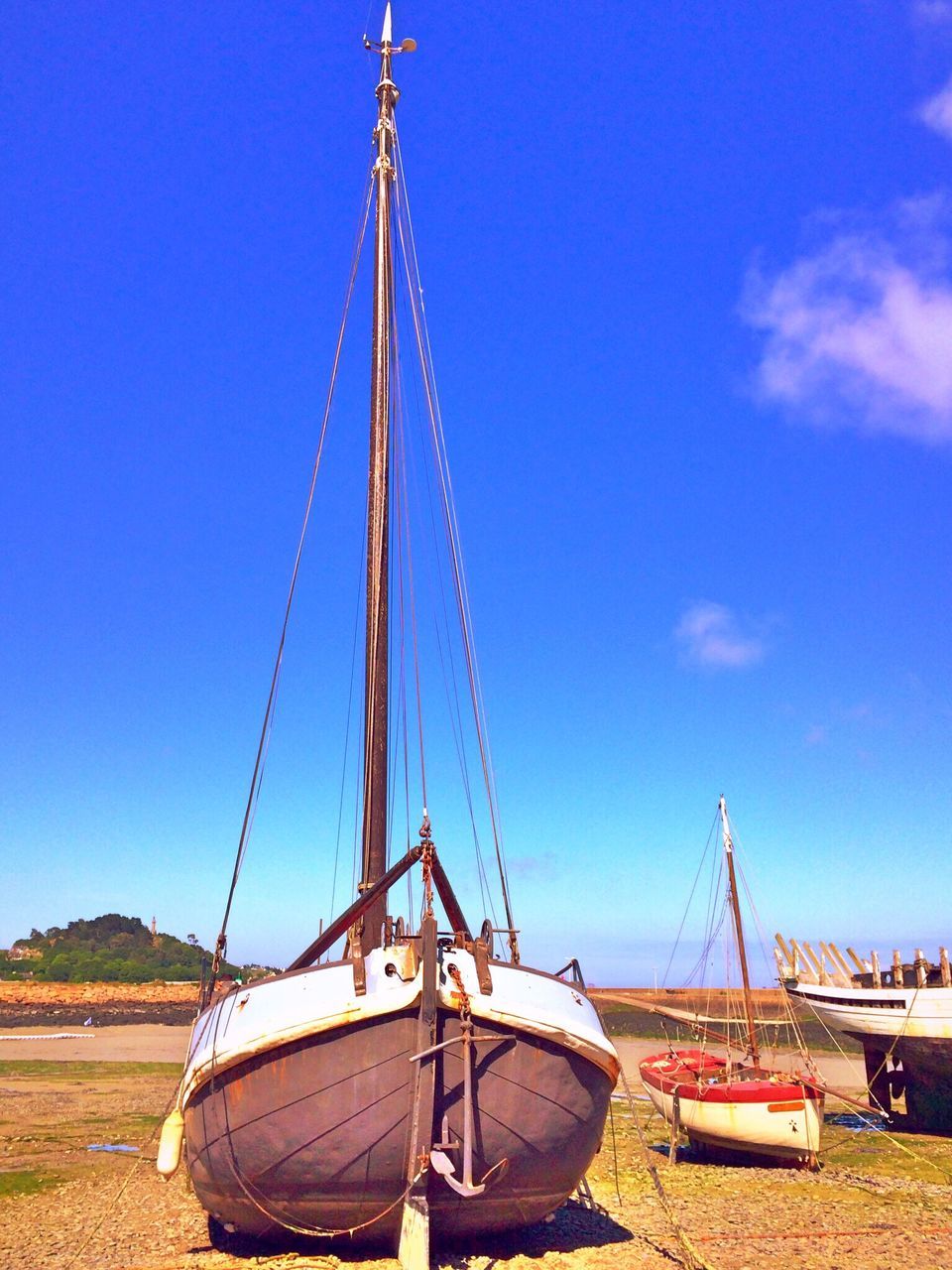 blue, transportation, clear sky, mode of transport, sky, landscape, sunlight, nautical vessel, day, outdoors, sand, travel, windmill, copy space, field, nature, environmental conservation, no people, metal, tranquil scene